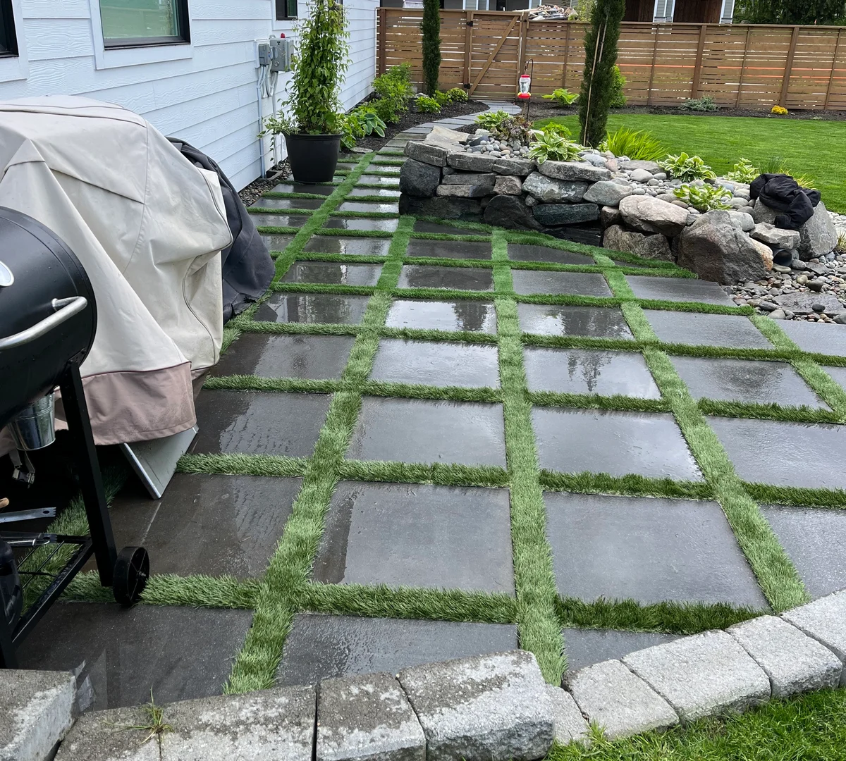 Stepping stone path with turf strips between concrete pavers
